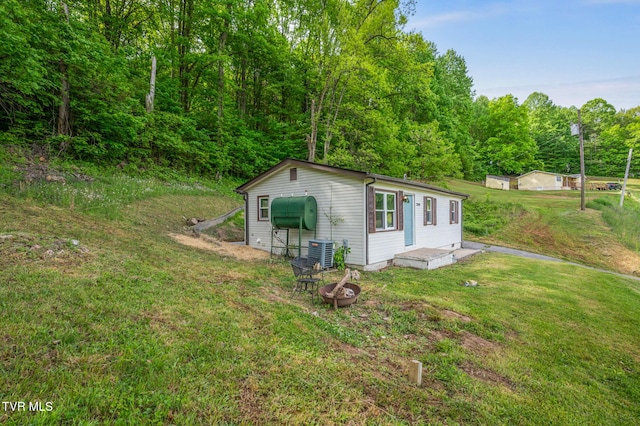 23249 Marys Chapel Rd, Bristol, VA 24202 - view of outdoor structure with central air condition unit, an outdoor fire pit, and a forest view