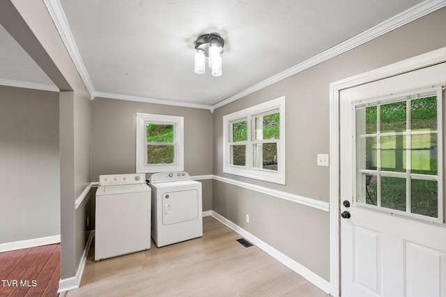 23249 Marys Chapel Rd, Bristol, VA 24202 - laundry room with washing machine and dryer, light wood-type flooring, healthy amount of natural light, and ornamental molding
