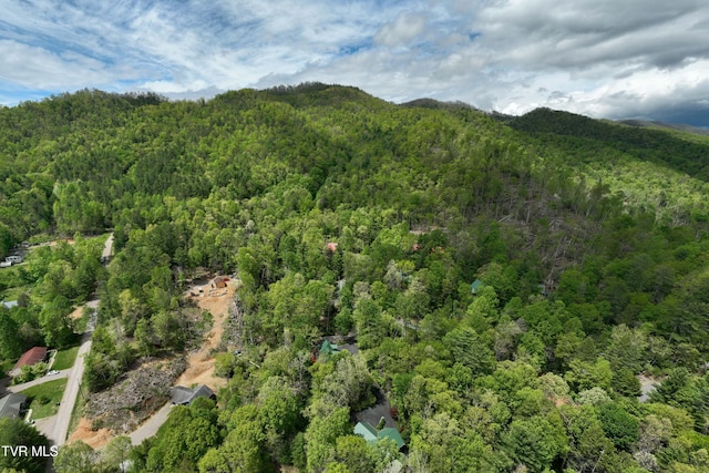 birds eye view of property featuring a view of trees