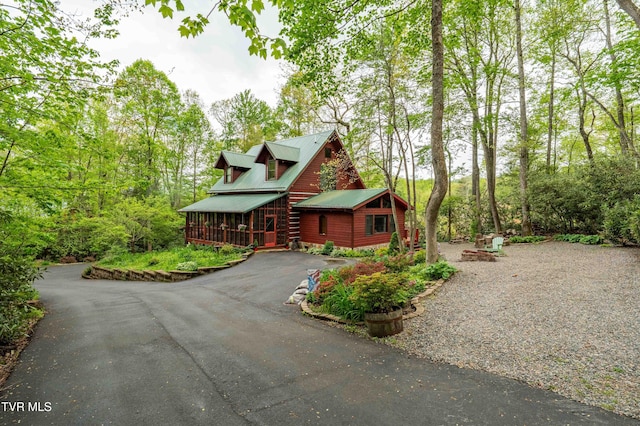 view of front of house featuring metal roof and aphalt driveway
