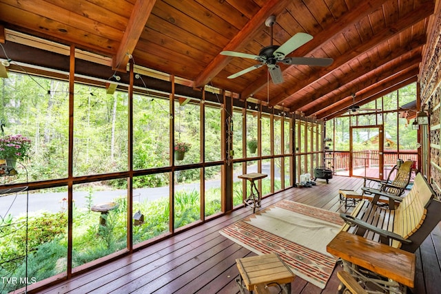 unfurnished sunroom with beamed ceiling and ceiling fan