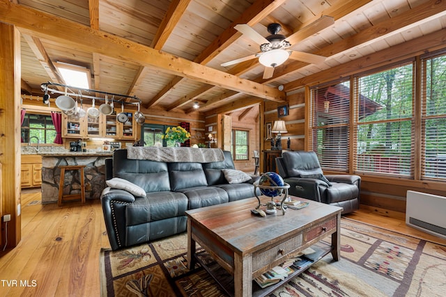 living room featuring a wealth of natural light, light wood-style flooring, and wooden ceiling