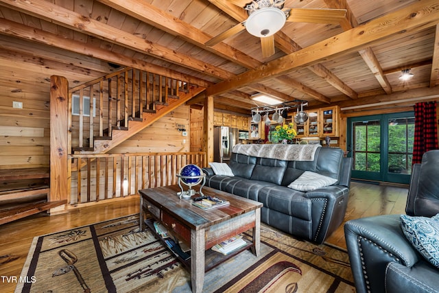living area with wood walls, ceiling fan, wood-type flooring, beamed ceiling, and wood ceiling