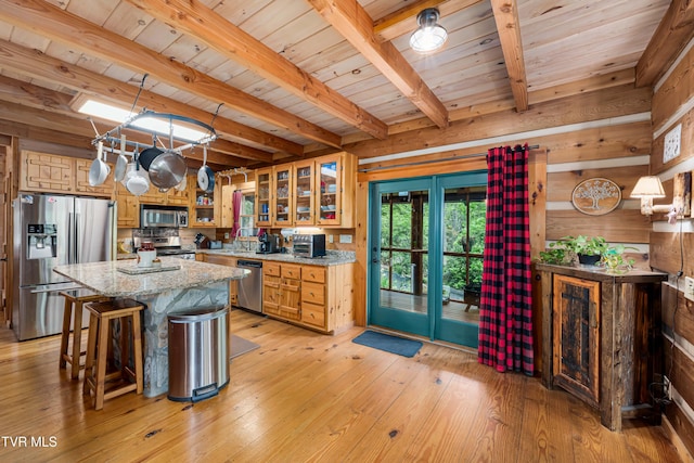 kitchen featuring wooden ceiling, stainless steel appliances, wood walls, and beam ceiling