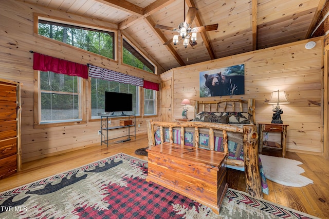 bedroom with wooden ceiling, wood walls, beam ceiling, and hardwood / wood-style floors