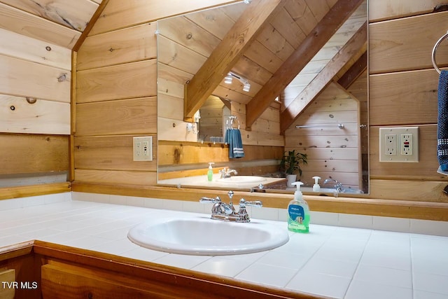 bathroom with wooden ceiling, wooden walls, vanity, and beamed ceiling