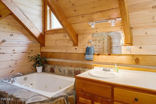 bathroom with a jetted tub, wood walls, and vanity