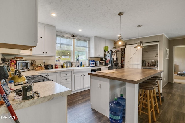 100 Colyer Rd, Greeneville, TN 37743 - kitchen with wooden counters, dark wood-type flooring, a kitchen breakfast bar, white cabinetry, and a textured ceiling