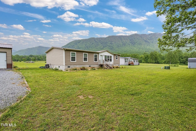 100 Colyer Rd, Greeneville, TN 37743 - rear view of property featuring crawl space, a mountain view, an outdoor structure, and a yard