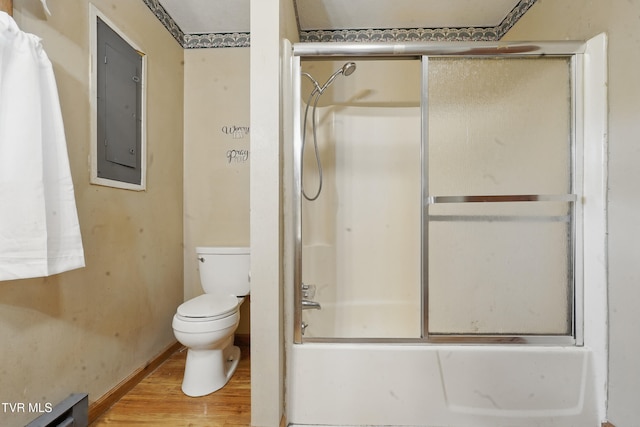 bathroom with toilet, baseboards, shower / bath combination with glass door, electric panel, and wood finished floors