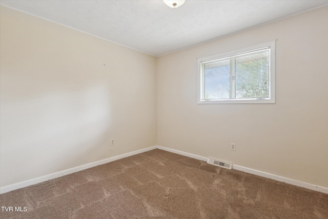 unfurnished room featuring carpet and baseboards
