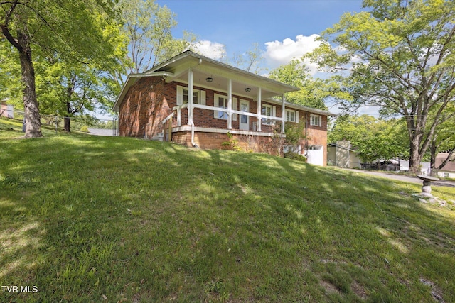 view of front of property with brick siding, a porch, and an attached garage