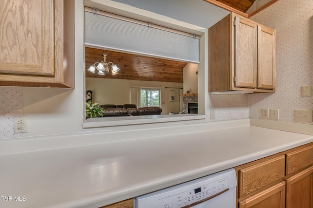 kitchen with lofted ceiling, white dishwasher, light countertops, and wallpapered walls