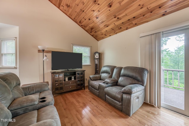 living area featuring light wood finished floors, a healthy amount of sunlight, high vaulted ceiling, and wood ceiling