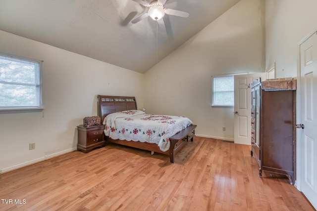 bedroom with light wood finished floors, a ceiling fan, baseboards, and lofted ceiling