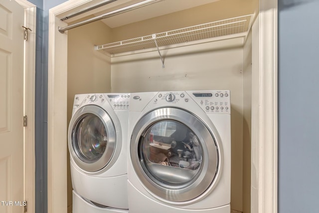 clothes washing area featuring washing machine and dryer and laundry area