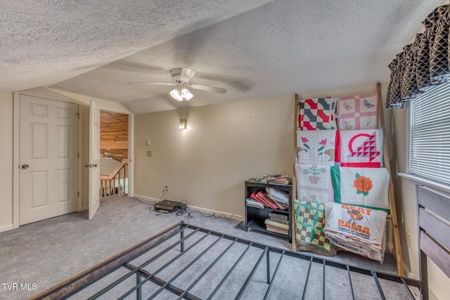 unfurnished bedroom featuring baseboards, carpet flooring, ceiling fan, and a textured ceiling