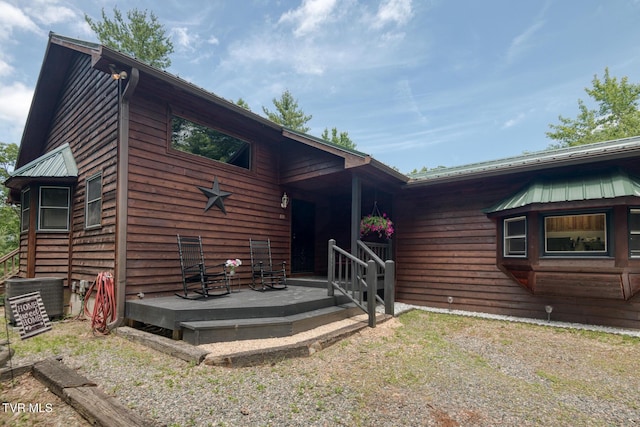 view of front of house with central air condition unit and metal roof