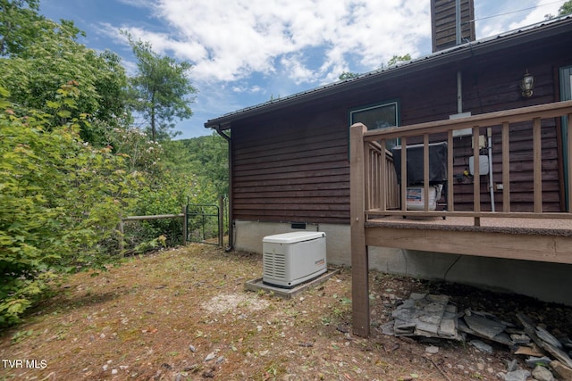 view of property exterior with a wooden deck