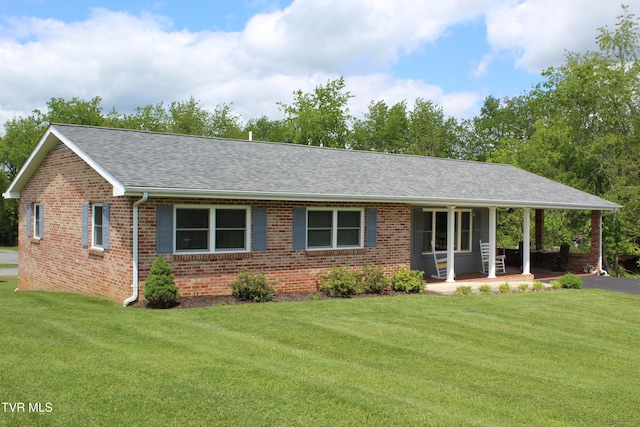 ranch-style home featuring a front lawn, brick siding, and a shingled roof