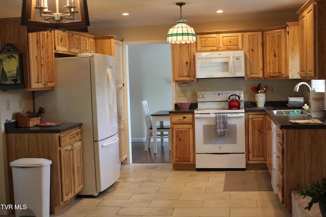 kitchen with white appliances, a sink, dark countertops, recessed lighting, and hanging light fixtures