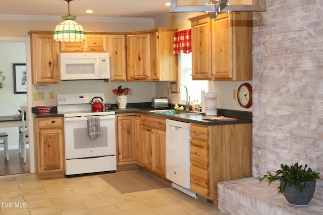 kitchen featuring white appliances, a sink, dark countertops, crown molding, and recessed lighting