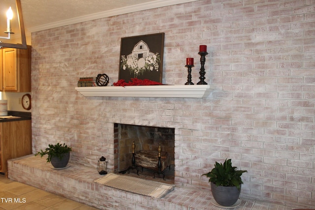 detailed view of ornamental molding, a brick fireplace, and wood finished floors