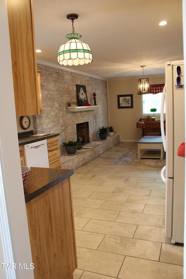 kitchen featuring white appliances, dark countertops, open floor plan, ornamental molding, and decorative light fixtures