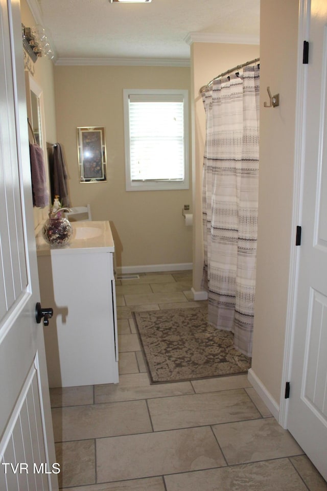 full bathroom featuring ornamental molding, vanity, a shower with shower curtain, and baseboards