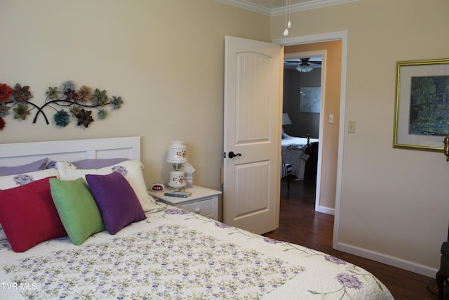 bedroom featuring crown molding, wood finished floors, and baseboards