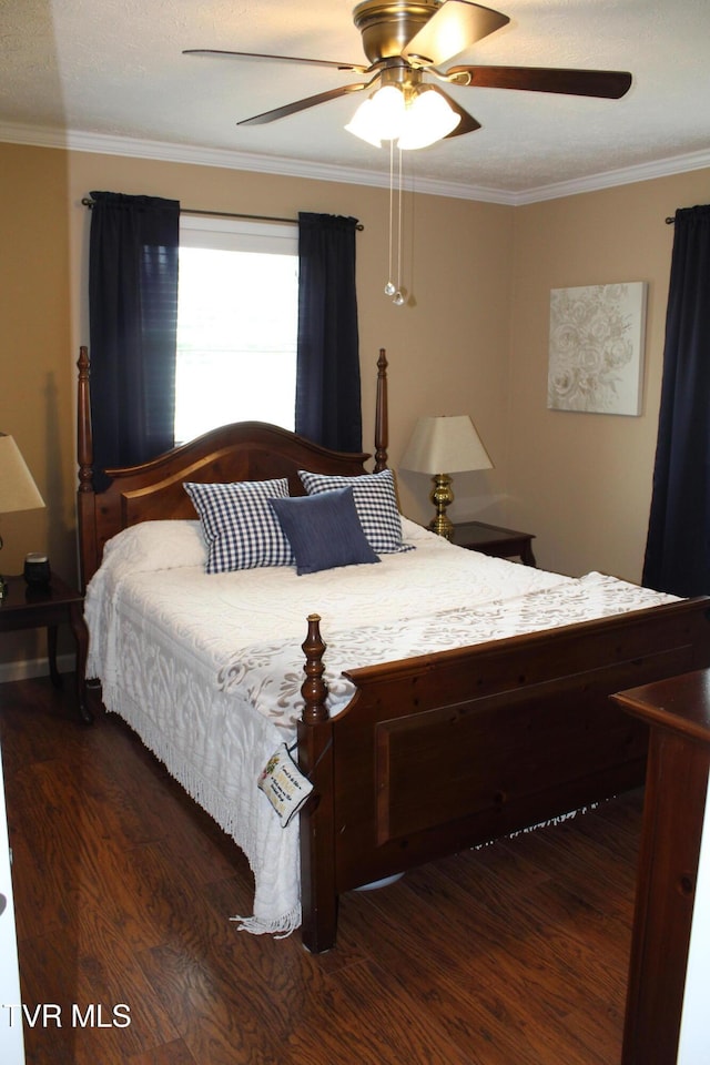 bedroom featuring wood finished floors, ornamental molding, and a ceiling fan