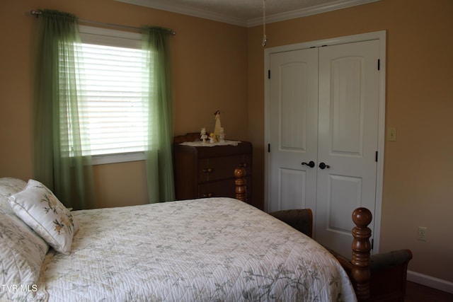 bedroom with a closet, multiple windows, ornamental molding, and baseboards