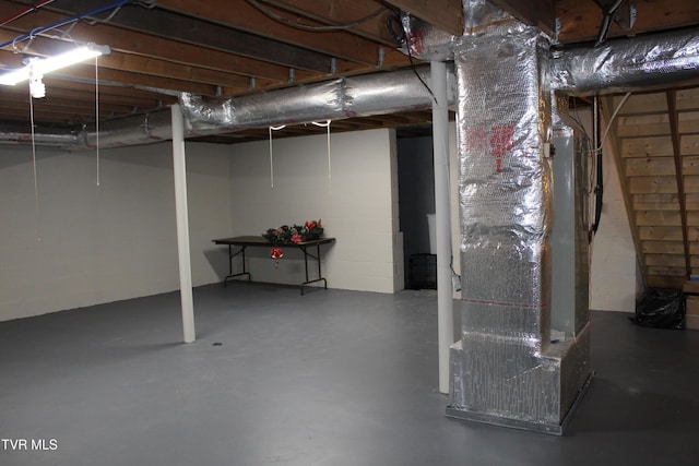 unfinished below grade area with heating unit and concrete block wall