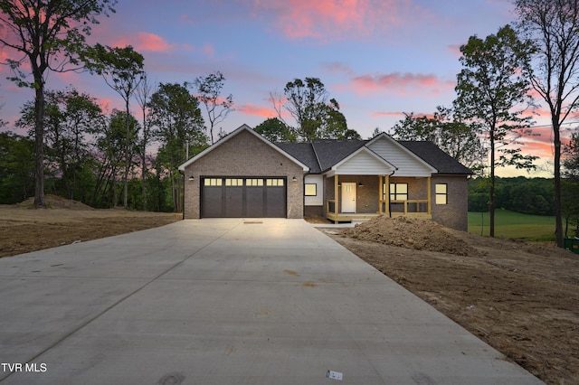 173 Paynetown Rd, Telford, TN 37690 - craftsman house with covered porch, driveway, brick siding, and a garage