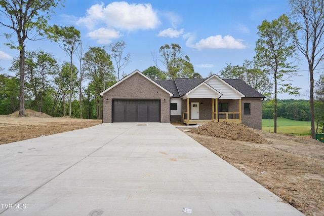173 Paynetown Rd, Telford, TN 37690 - view of front facade with concrete driveway, a porch, brick siding, and a garage