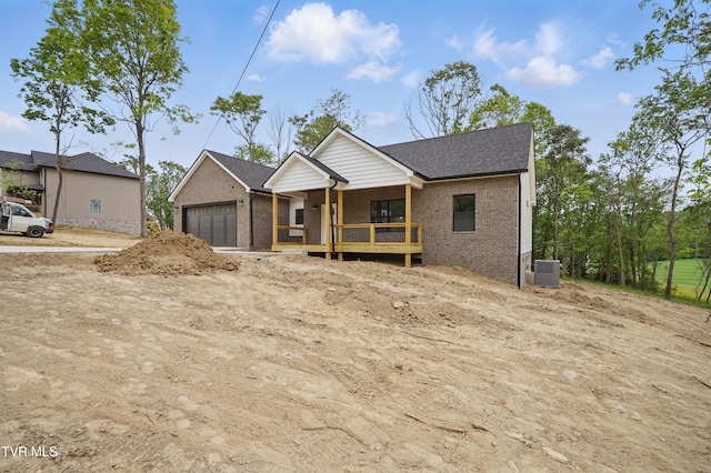 173 Paynetown Rd, Telford, TN 37690 - property in mid-construction with central air condition unit, a porch, brick siding, and an attached garage