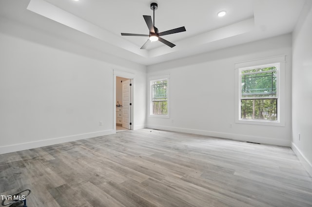 173 Paynetown Rd, Telford, TN 37690 - empty room featuring a raised ceiling, baseboards, a ceiling fan, and wood finished floors