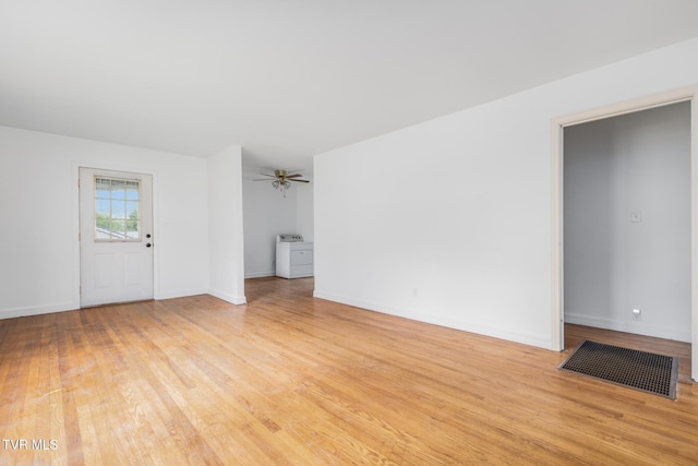 216 Sunbury Ct, Kingsport, TN 37664 - unfurnished living room with light wood-type flooring, washer / clothes dryer, ceiling fan, and baseboards