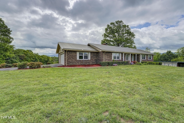 single story home with an attached garage, brick siding, a front yard, and metal roof