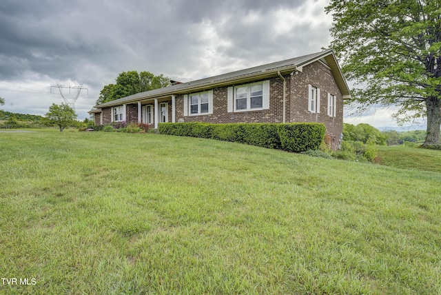 ranch-style house with brick siding and a front lawn