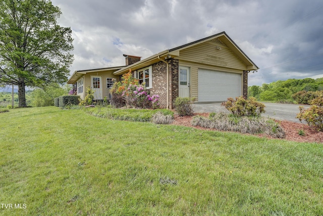 view of front of house featuring concrete driveway, an attached garage, a chimney, a front lawn, and brick siding