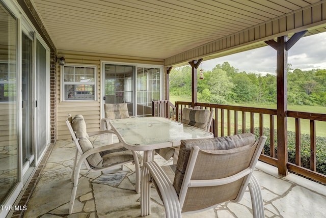wooden terrace with outdoor dining space