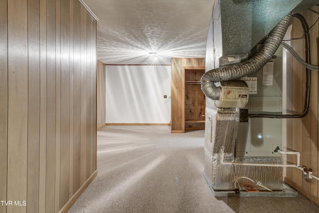 corridor featuring wood walls, carpet, and baseboards