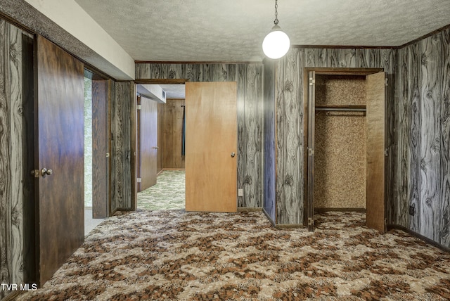 unfurnished bedroom with carpet and a textured ceiling