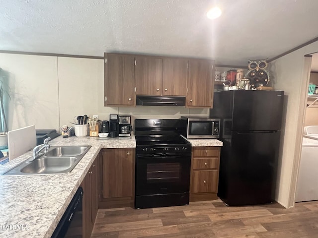 28529 US Highway 23, Big Stone Gap, VA 24219 - kitchen with a sink, black appliances, under cabinet range hood, light countertops, and washer / clothes dryer