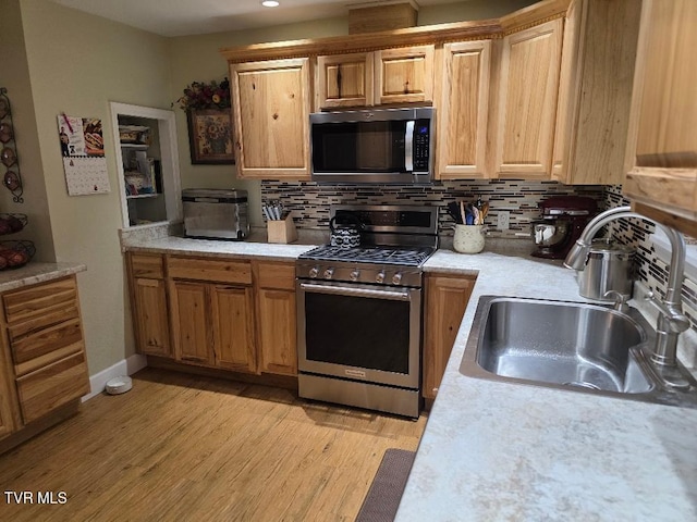214 Elliott, Erwin, TN 37650 - kitchen with stainless steel appliances, a sink, light countertops, light wood finished floors, and tasteful backsplash