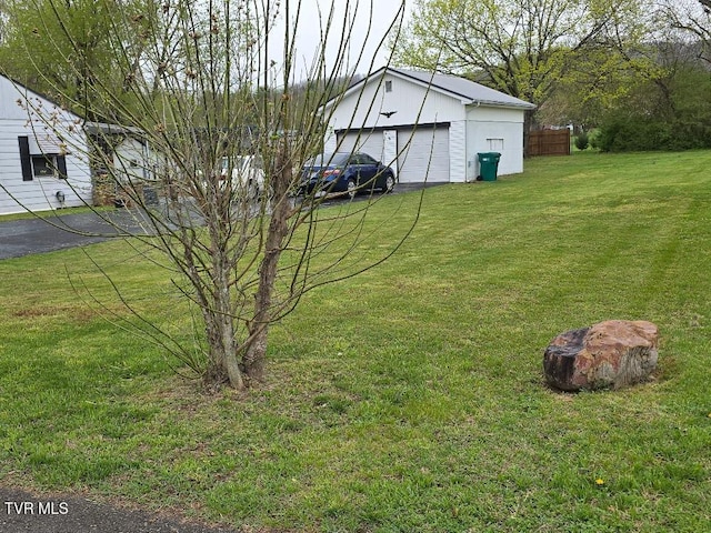 214 Elliott, Erwin, TN 37650 - view of yard with a detached garage and an outbuilding