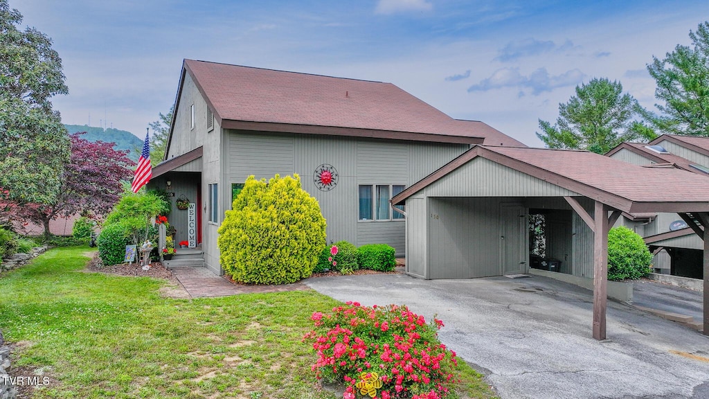 150 Aston Pl Unit 150, Kingsport, TN 37660 - view of front of house with a front yard, driveway, a carport, and roof with shingles