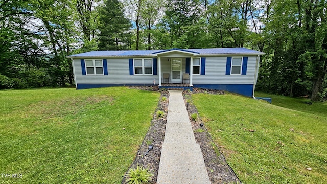 824 W Buckner Ave, Big Stone Gap, VA 24219 - manufactured / mobile home featuring a front lawn, covered porch, metal roof, and view of scattered trees