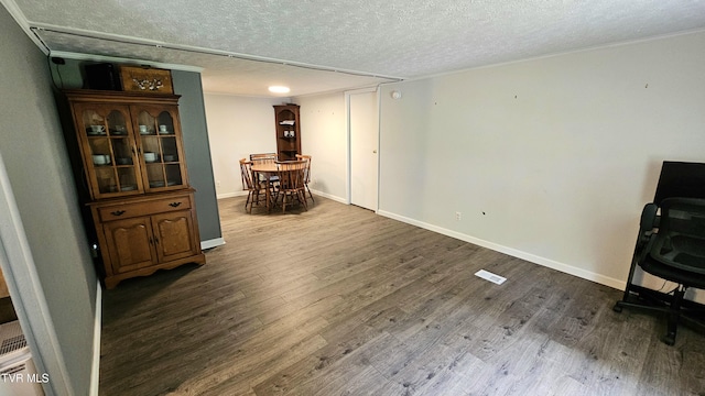 824 W Buckner Ave, Big Stone Gap, VA 24219 - dining room featuring a textured ceiling, dark wood-style floors, and baseboards